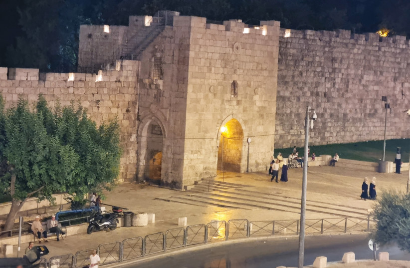  The Flower Gate to the Old City is seen at night in downtown eastern Jerusalem. (credit: SHMUEL BAR-AM)