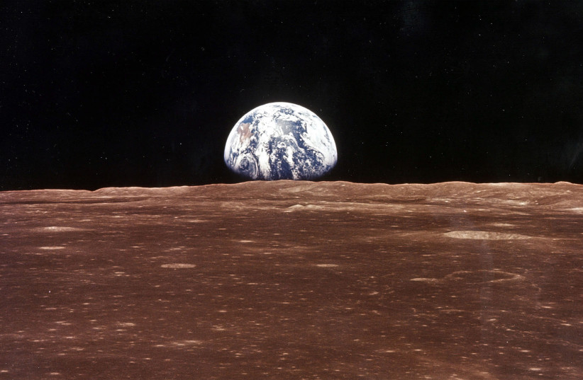  ‘WHY DO people live on Earth?’: Earth appears over the lunar horizon as the ‘Apollo 11’ command module comes into view of the moon, before Astronauts Neil Armstrong and Edwin Aldrin Jr. leave in the lunar module, to become the first men to walk on the moon’s surface on July 20, 1969.  (credit: NASA/Newsmakers)