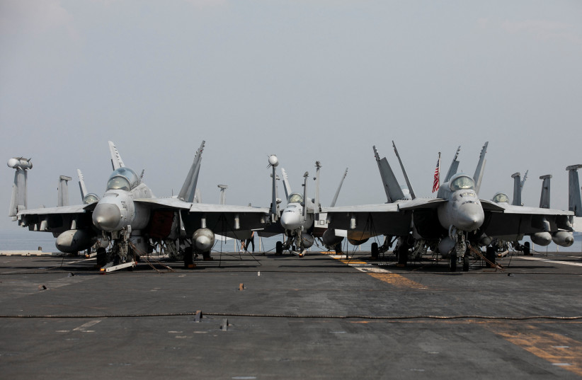  U.S. Navy F-18 fighter jets are parked on the deck of aircraft carrier USS Ronald Reagan (CVN 76) during a goodwill visit in Manila, Philippines, October 14, 2022.  (credit: REUTERS/ELOISA LOPEZ)