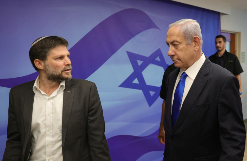  Israeli Prime Minister Benjamin Netanyahu speaks with Finance Minister Bezalel Smotrich during the weekly cabinet meeting at the prime minister's office in Jerusalem, 25 June 2023.  (credit: ABIR SULTAN/POOL/VIA REUTERS)