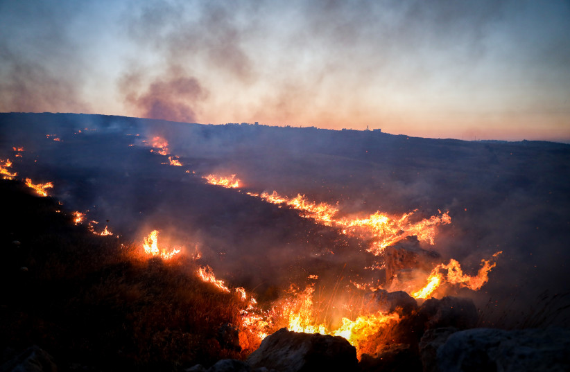 A fire is seen raging in a field during clashes between Palestinians and Israeli Jewish settlers in the West Bank, on June 22, 2023.