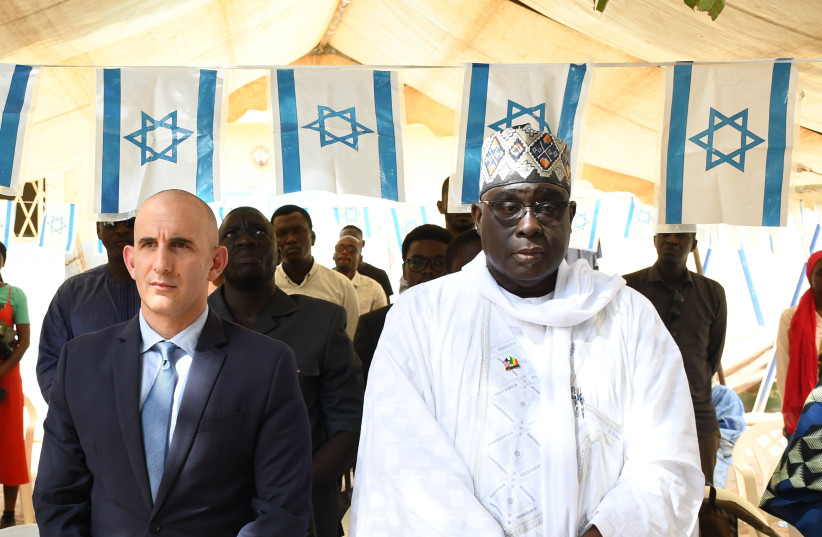Senegal's ambassador to Israel stands under Israeli flags. (credit: COURTESY / WALEED GADBAN, SENEGAL'S AMBASSADOR TO ISRAEL)