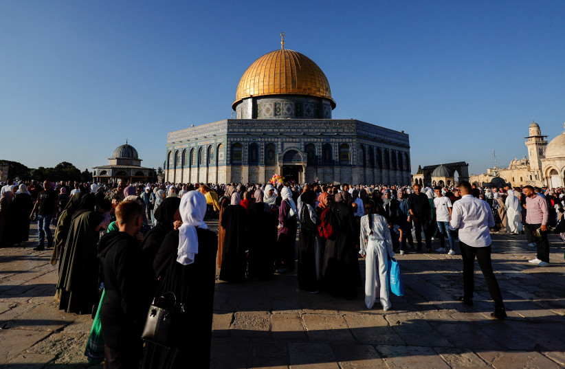 Palestinians celebrate the first day of the Muslim holiday of Eid al-Adha in the Al-Aqsa compound, also known to Jews as the Temple Mount, in Jerusalem's Old City June 28, 2023. (credit: AMMAR AWAD/REUTERS)