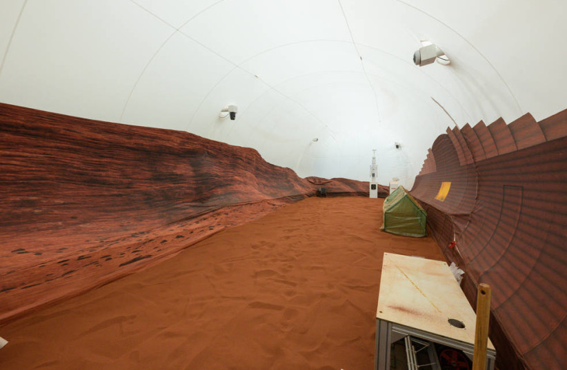  NASA’s simulated Mars habitat includes a 1,200-square-foot sandbox with red sand to simulate the Martian landscape. The area will be used to conduct simulated spacewalks or “Marswalks” during the analog missions. (credit: NASA)