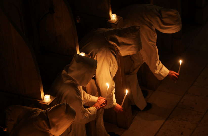 Catholic nuns from the Sisters of Bethlehem hold candles as they take part in Christmas Eve mass at the Beit Jamal Monastery near Beit Shemesh, December 24, 2022. (credit: NIR ELIAS/REUTERS)