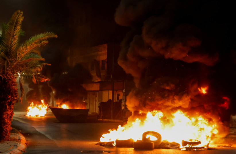  View of tires set on fire on a street after a Palestinian was killed during an IDF strike in Jenin July 3, 2023. (credit: REUTERS)