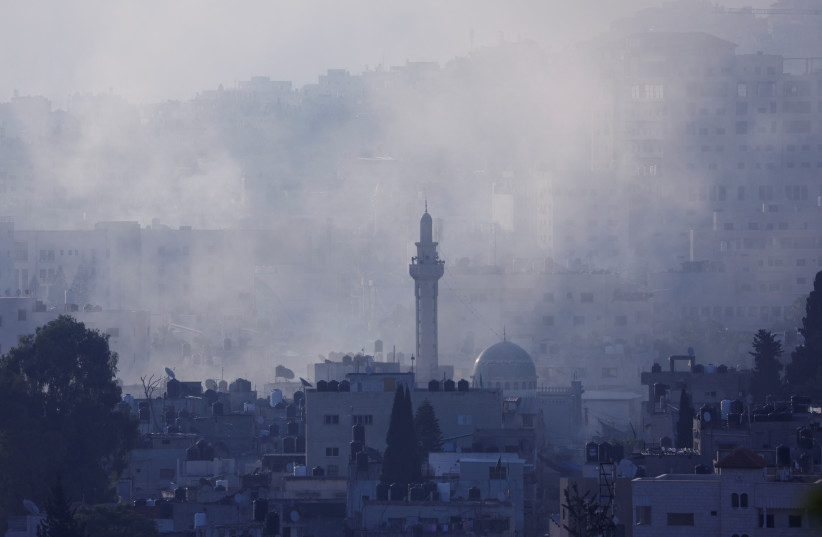  Smoke rises during an Israeli military operation in Jenin, in the West Bank July 3, 2023.  (credit: REUTERS/MOHAMAD TOROKMAN)