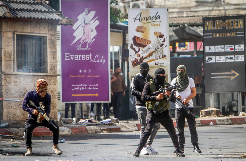  Palestinians carrying weapons seen as Israel began a major aerial and ground offensive in the West Bank city of Jenin, in one of its biggest military operation in the Palestinian territory in years. July 3, 2023.  (credit: NASSER ISHTAYEH/FLASH90)