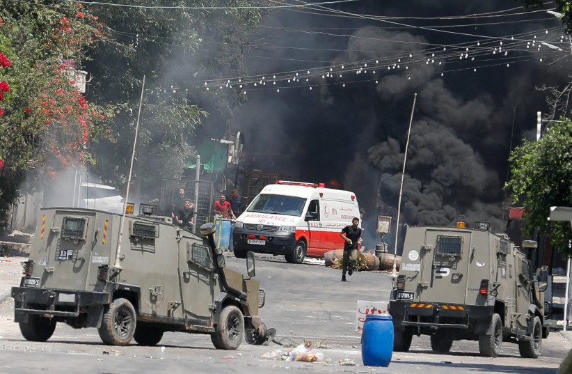  Palestinians clash with Israeli forces during an Israeli military operation in Jenin, in the West Bank July 3, 2023 (credit: REUTERS/RANEEN SAWAFTA)