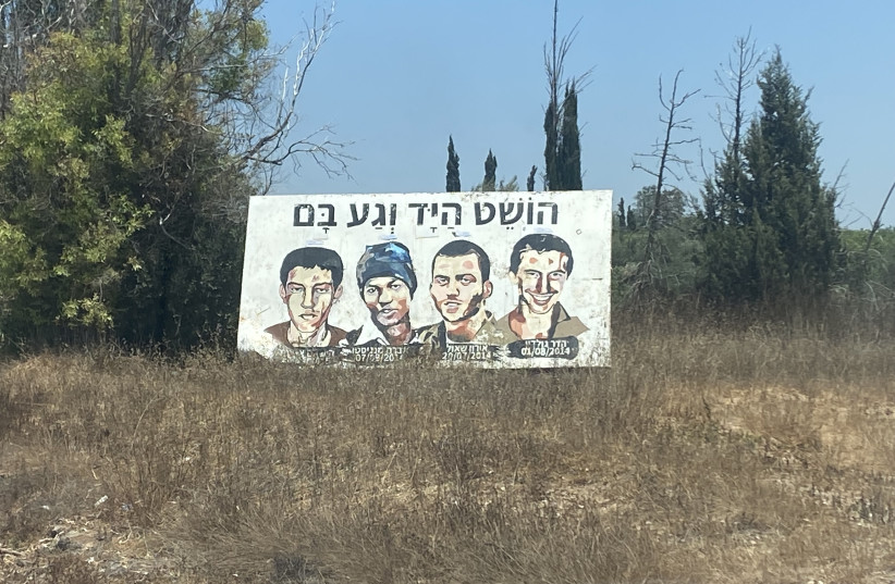  Photo of a mural reminding people near Gaza of the two civilians, Avraham (Avera) Mengistu and Hisham al-Sayed, who are currently being held by Hamas in the Gaza Strip and the bodies of fallen Israel Defense Forces soldiers, Hadar Goldin and Oren Shaul, held by Hamas (credit: SETH J. FRANTZMAN)