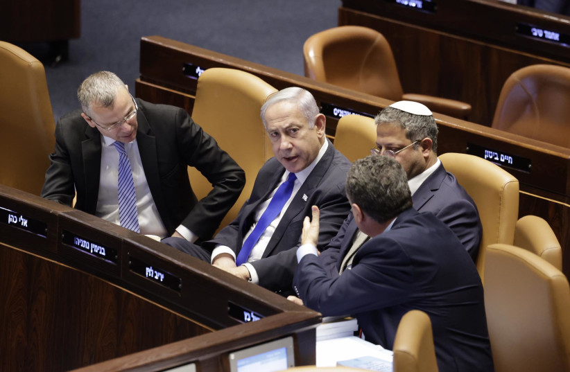  Israeli Prime Minister Benjamin Netanyahu is seated next to his fellow coalition lawmakers, in the Knesset in Jerusalem, on July 10, 2023. (credit: MARC ISRAEL SELLEM/THE JERUSALEM POST)