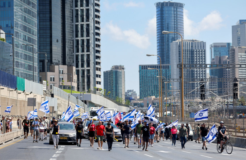  People demonstrate on 'Day of Paralysis' in protest against Israeli Prime Minister Benjamin Netanyahu and his nationalist coalition government's judicial overhaul, in Tel Aviv, Israel July 11, 2023. (credit: REUTERS/NIR ELIAS)