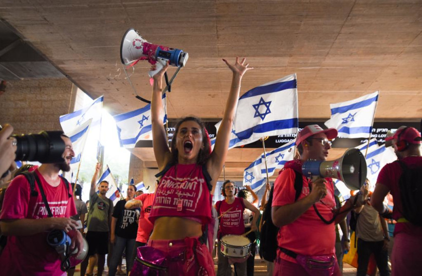  Demonstrators holding up signs and protesting at Ben Gurion Airport (credit: I.H. Mintz)