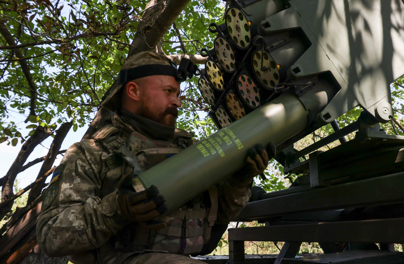  A Ukrainian serviceman loads a shell into a RAK-SA-12 small multiple launch rocket system before firing towards Russian troops near the front line town of Bakhmut, amid Russia's attack on Ukraine, in Donetsk region, Ukraine July 10, 2023. (credit: REUTERS/SOFIIA GATILOVA)