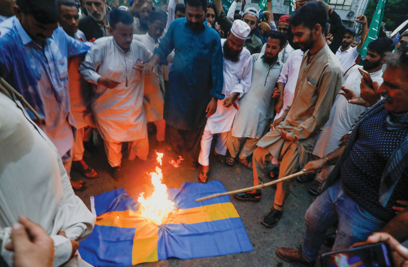  BURNING A Swedish flag to denounce the desecration of a Koran outside a Stockholm mosque, in Karachi, Pakistan, July 7. (credit: Akhtar Soomro/Reuters)
