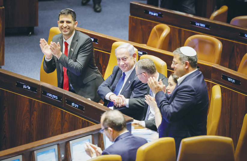  PRIME MINISTER Benjamin Netanyahu congratulates Justice Minister Yariv Levin and other coalition members on Monday night, after the passage in first reading of the reasonableness bill. (credit: MARC ISRAEL SELLEM/THE JERUSALEM POST)