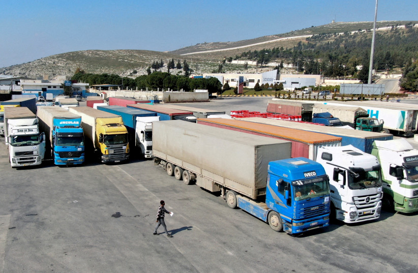 Trucks carrying aid from the UN World Food Programme (WFP), following a deadly earthquake, are parked at Bab al-Hawa crossing, Syria, February 20, 2023 (credit: REUTERS/MAHMOUD HASSANO)