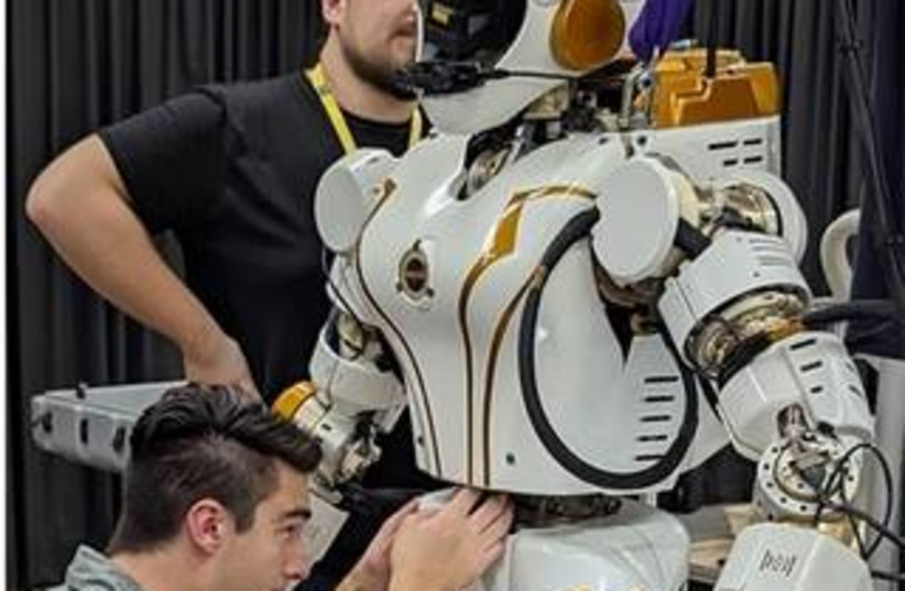 NASA Dexterous Robotics engineers Alex Sowell and Misha Savchenko setting up the Valkyrie robot at Woodside Energy. (credit: Credits: NASA/JSC)