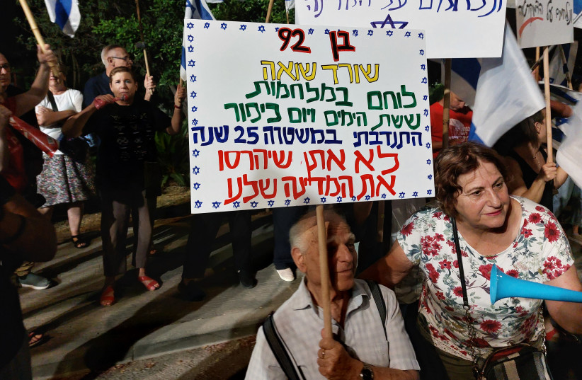  Saturday night's Ma'aleh Adumim demonstration against government's judicial legislation. The sign says: I'm 92, a Holocaust survivor, veteran of the 6-Day War and Yom Kippur war, and a police volunteer for 25 years. I won't let them destroy our country. (credit: DAVID BRINN)