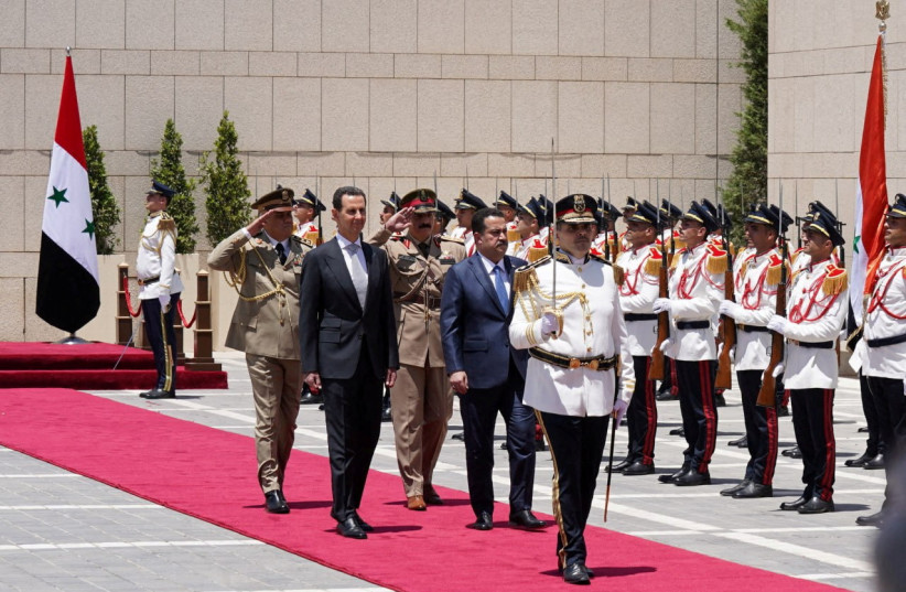  Syria's President Bashar al-Assad and Iraqi Prime Minister Mohammed Shia Al-Sudani review an honor guard in Damascus, Syria July 16, 2023. (credit: SYRIAN PRESIDENCY/HANDOUT VIA REUTERS)