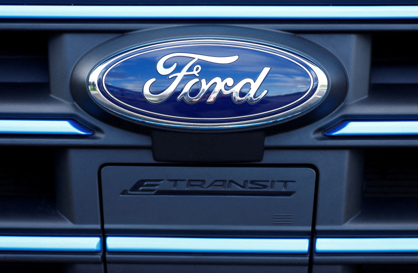  The Ford badge and E-Transit logo are seen on a vehicle at Ford’s Dunton Technical Centre in Dunton, Britain, January 13, 2023. (credit: REUTERS/PETER NICHOLLS/FILE PHOTO)
