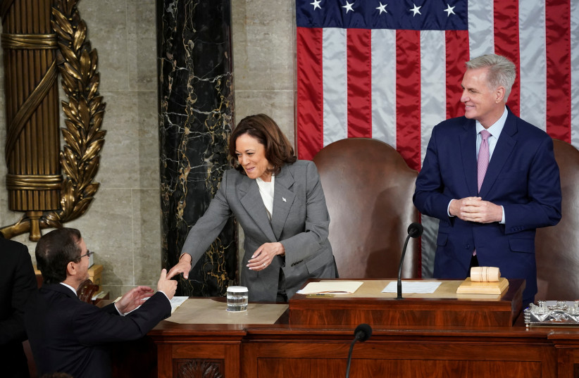 Israeli President Isaac Herzog is greeted by US Vice President Kamala Harris as US House Speaker Kevin McCarthy (R-CA) looks on prior to Herzog's address to a joint meeting of Congress in the House Chamber of the US Capitol in Washington, US, July 19, 2023.  (credit: KEVIN LAMARQUE/REUTERS)