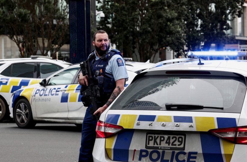  Armed police stand guard near a construction site following a shooting in the central business district, in Auckland, New Zealand July 20, 2023. (credit: REUTERS/David Rowland)