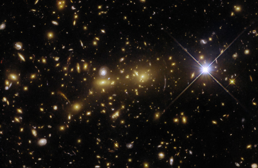 NASA image of the galaxy cluster eMACS J1353.7+4329. (credit: ESA/Hubble & NASA, H. Ebeling)