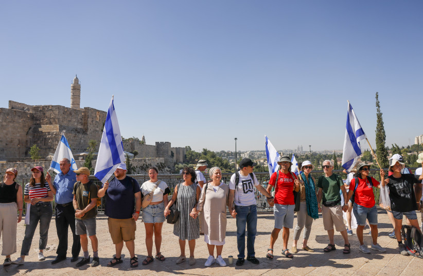  Anti-judicial overhaul activists participate in a ''human chain'' event after taking part in a special prayer at the Western Wall in Jerusalem's Old City, and continuing to the knesset, Israeli parliament, on July 23, 2023. (credit: Chaim Goldberg/Flash90)