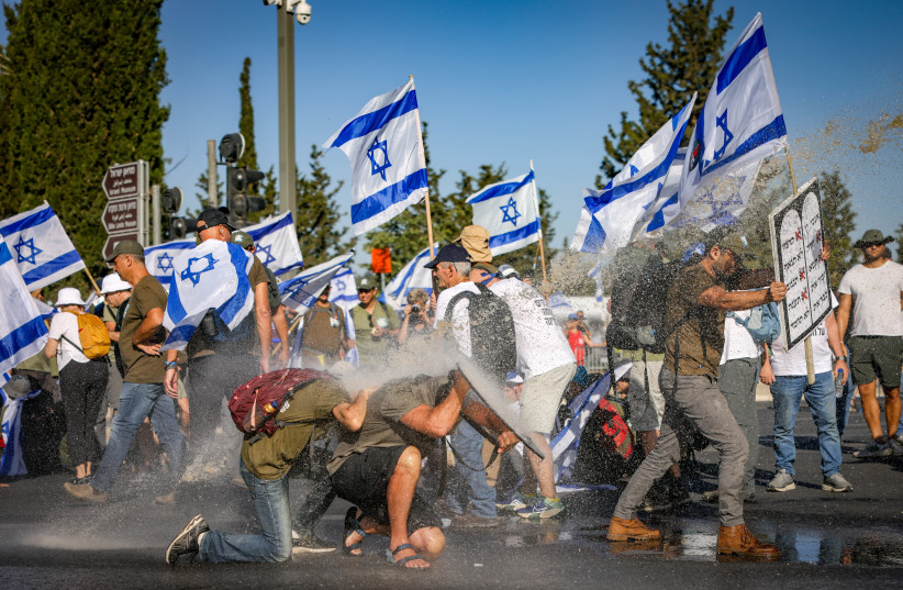 Anti-judicial overhaul activists block a raod during a protest against the government's judicial overhaul, near the Knesset, the Israeli parliament in Jerusalem, on July 24, 2023.  (credit: Chaim Goldberg/Flash90)