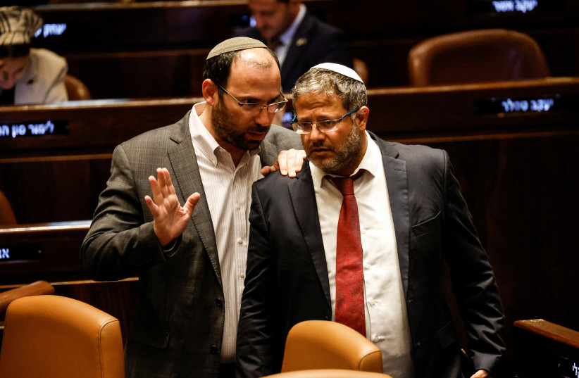 Israeli National Security Minister Itamar Ben-Gvir and Head of the Knesset Constitution, Law and Justice Committee Simcha Rothman speak as lawmakers gather at the Knesset plenum to vote on a bill that would limit some Supreme Court power, in Jerusalem July 24, 2023.