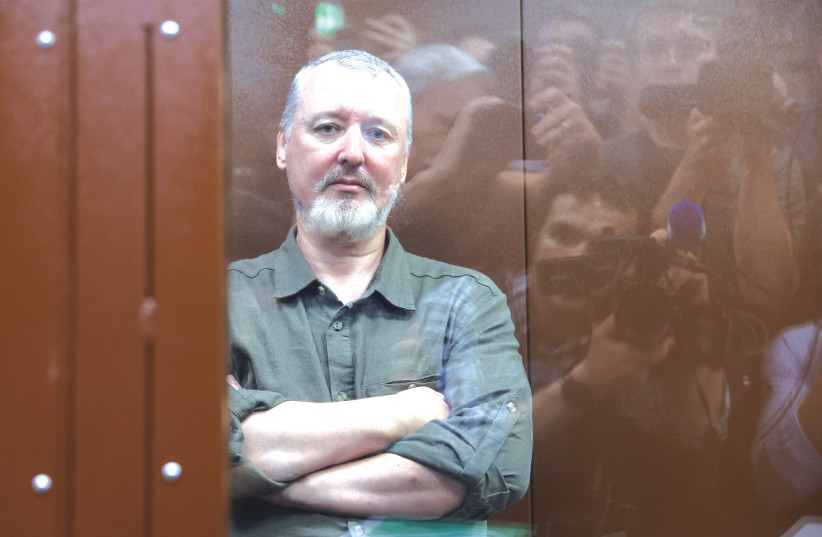  IGOR GIRKIN, charged with inciting extremist activity, sits behind a glass wall of an enclosure for defendants, before a court hearing in Moscow. (credit: REUTERS/Yulia Morozova)
