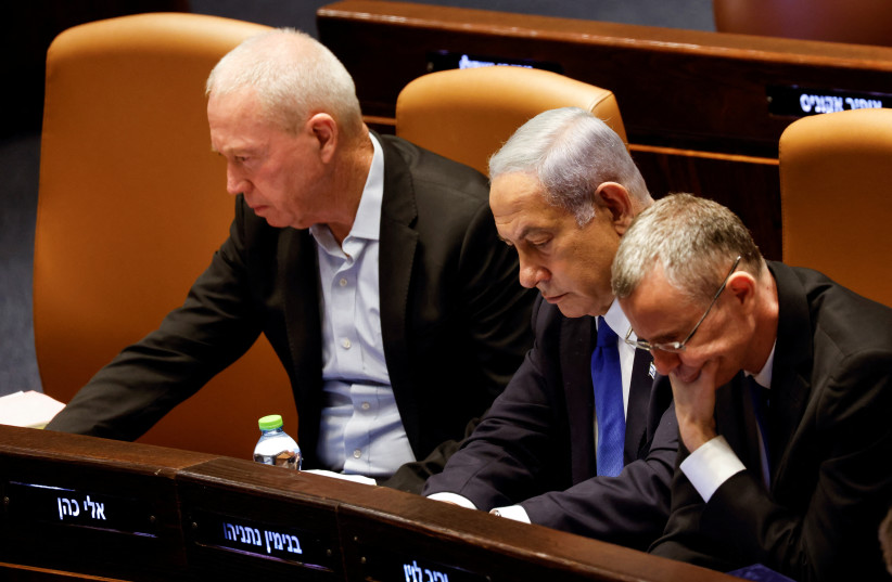  Prime Minister Benjamin Netanyahu sits between Justice Minister Yariv Levin and Defense Minister Yoav Gallant at the Knesset plenum in Jerusalem July 24, 2023 (credit: REUTERS/AMIR COHEN)