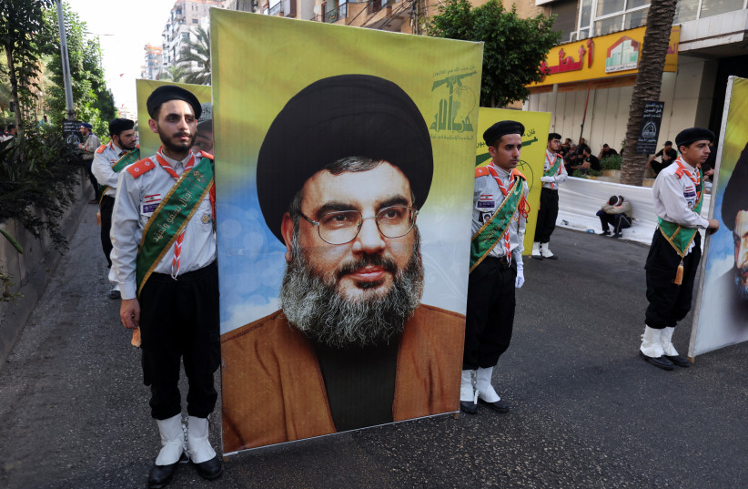 Members of Imam al-Mahdi scouts carry a picture of Lebanon's Hezbollah leader Sayyed Hassan Nasrallah, during a religious procession to mark Ashura in Beirut’s southern suburbs, Lebanon July 29, 2023 (credit: REUTERS/AZIZ TAHER)