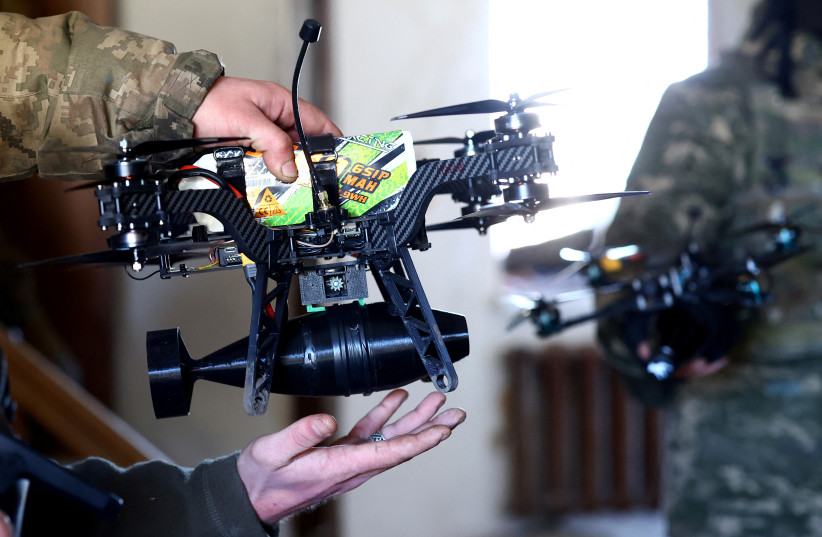 A Ukrainian serviceman of the 1st Independent Tank Brigade holds a drone with a granate, as Russia's attack on Ukraine continues, near the frontline of Vuhledar, in Donetsk region, Ukraine March 4, 2023
