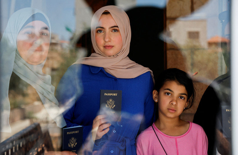  Palestinian family hold their American passports in their house that was torched by Israeli settlers, in Turmus Ayya, near Ramallah, in the West Bank June 23, 2023 (credit: REUTERS)