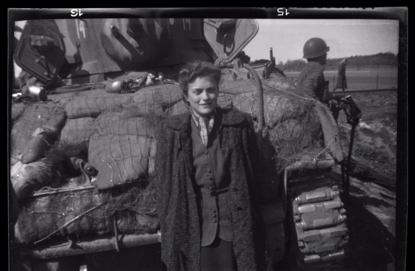  Gina Rappaport (later Leitersdorf) stands next to an American tank shortly after her liberation.  She had survived the Warsaw ghetto prior to her incarceration in Bergen-Belsen. (credit: United States Holocaust Memorial Museum, courtesy of George Gross.)