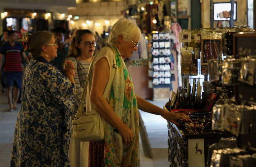  Foreign tourists shop at Souq Waqif in Doha, Qatar, October 20, 2019. (credit: NASEEM ZEITOON/REUTERS)