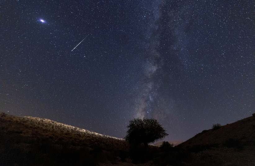 A meteor streaks past stars in the night sky during the annual Perseid meteor shower at the Negev Desert in southern Israel, August 13, 2021. (credit: AMIR COHEN/REUTERS)