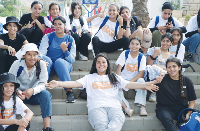  BEDOUIN AND Jewish teenage girls relax at the One Team joint summer camp initiated by the Azrieli Foundation. (credit: Courtesy Azrieli Foundation)