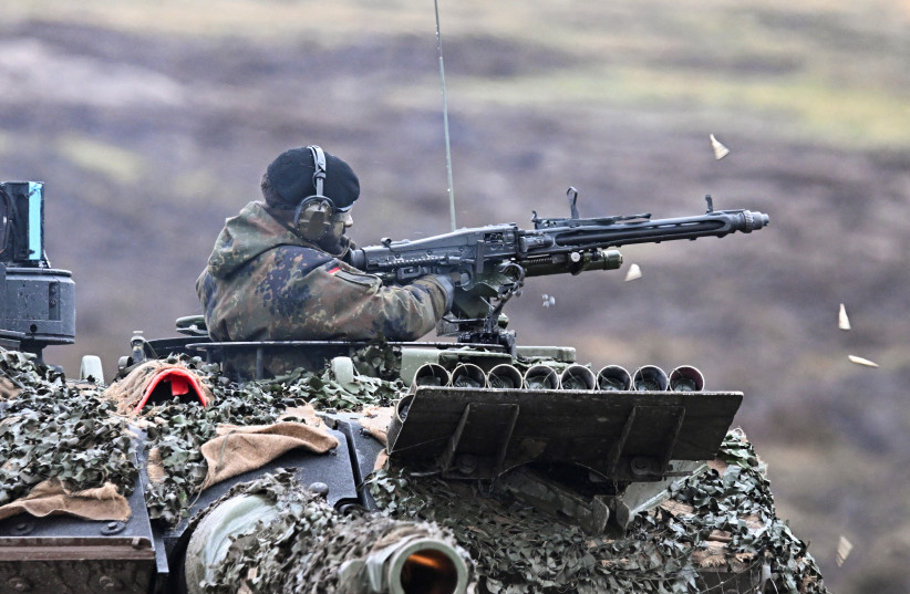  A tank crew member fires a tank mounted machine gun as German Defense minister Boris Pistorius visits Leopard II tanks that are due to be supplied to Ukraine at the tank brigade Lipperland of Germany's army and part of the Bundeswehr, in Augustdorf, Germany, February 1, 2023 (credit: REUTERS/BENJAMIN WESTHOFF)