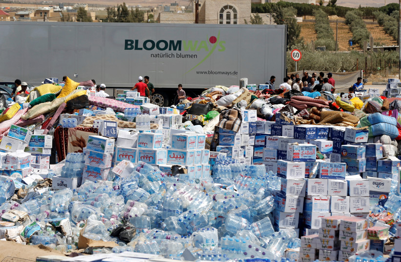  Humanitarian aid is prepared to be delivered to Syria, in the town of Ramtha, Jordan (credit: REUTERS/MUHAMMAD HAMED)