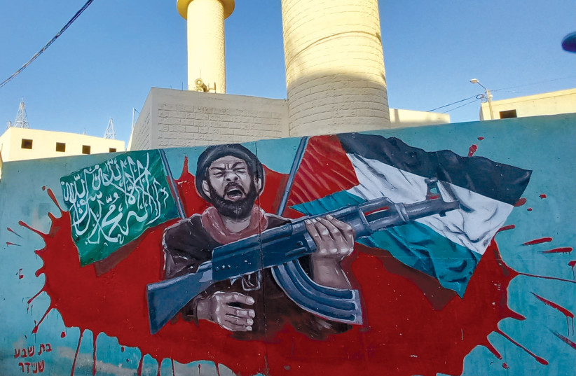 In a mock-up of a Palestinian town, Batsheva Schneider painted an Islamic Jihad mural in front of mosque minarets. (credit: GIL ZOHAR)