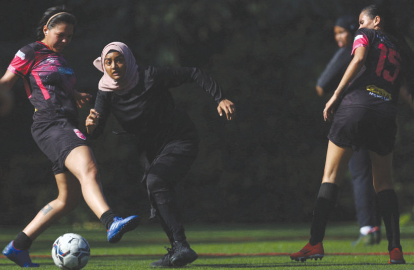  SISTERHOOD FOOTBALL Club, a Muslim women’s team with hijab-wearing members, plays on a soccer pitch in a central London, UK, park.  (credit: Hannah McKay/Reuters)