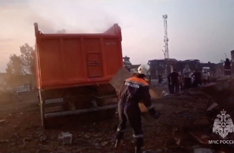  Russian emergencies ministry members remove debris at the accident scene following an explosion at a gas station in Makhachkala in the region of Dagestan, Russia, August 15, 2023, in this still image taken from video.  (credit: Russian Emergencies Ministry/Handout via REUTERS)