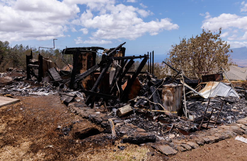  A view of the remains of a residential home after it was destroyed during the wildfires, in Kula on Maui island, Hawaii, US, August 13, 2023. (credit: REUTERS/MIKE BLAKE)