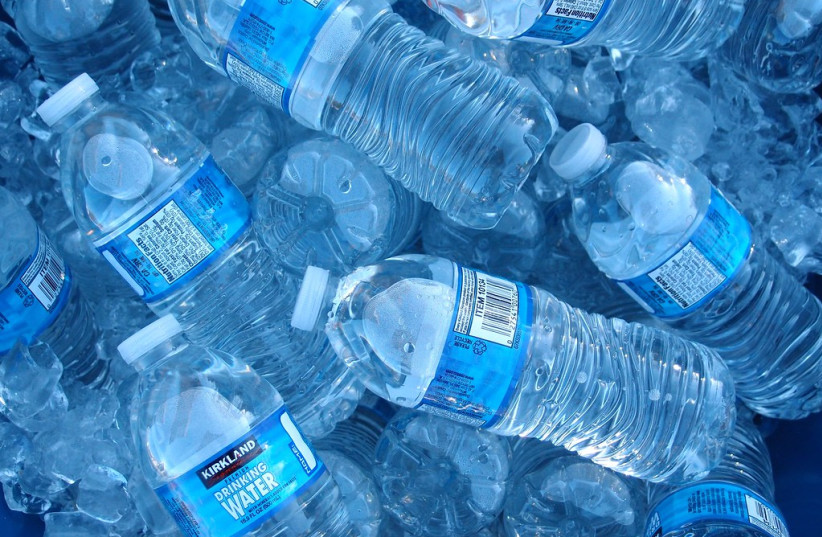 A pile of bottled drinking water with blue labels.  (credit: FLICKR)