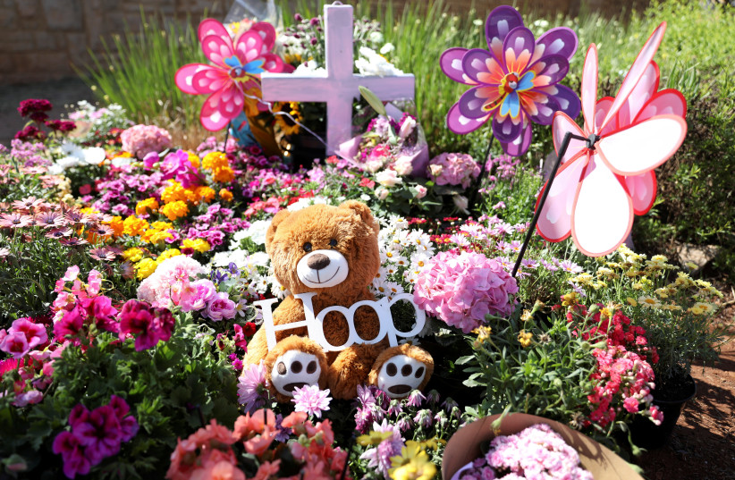  A teddy bear is seen among flowers placed outside where Lauren Anne Dickason, a woman charged with murdering her three young daughters just weeks after arriving in New Zealand from South Africa, used to live, in Pretoria, South Africa, September 24, 2021. (credit: REUTERS/SIPHIWE SIBEKO)