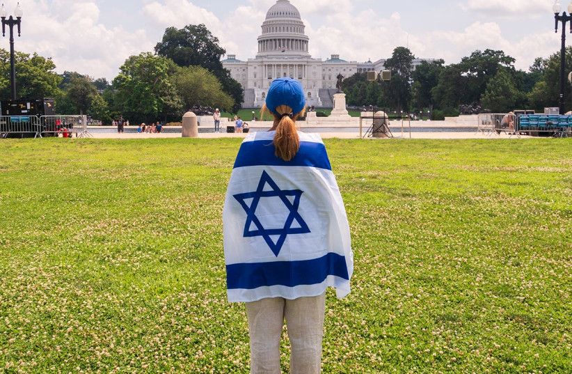  A young woman wearing an Israeli flag. (credit: MELANIE PHILLIPS)