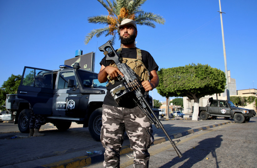  A member of the Security personnel affiliated with the Ministry of Interior secures the street after yesterday's clashes between armed factions in Tripoli, Libya, August 16, 2023. (credit: REUTERS/HAZEM AHMED)